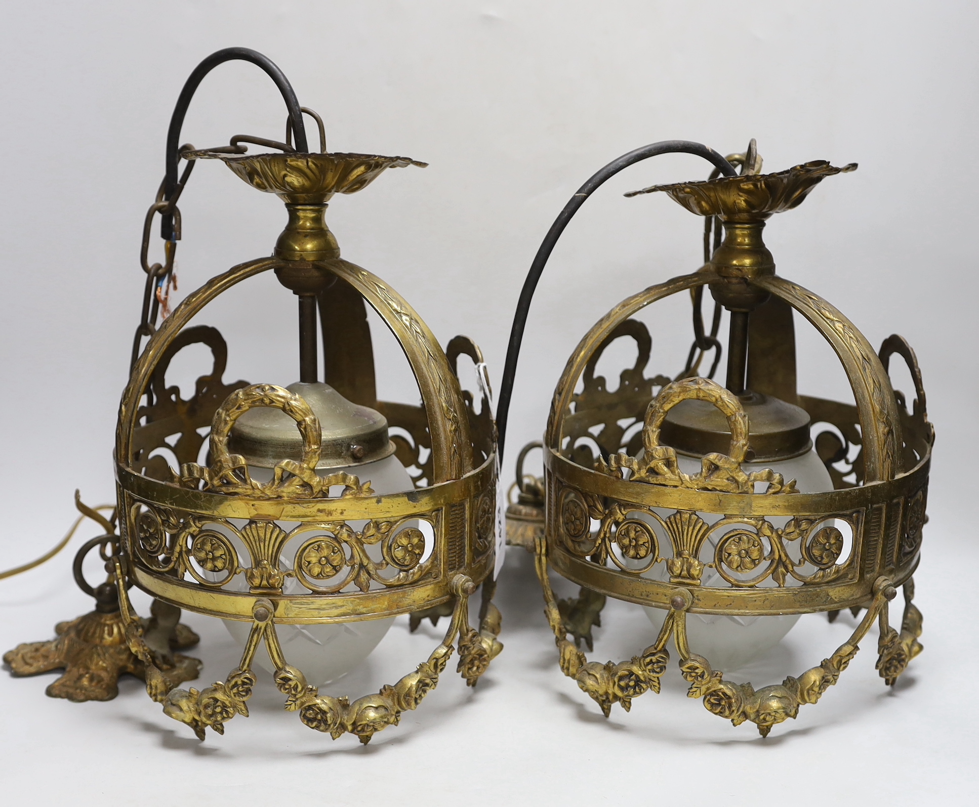 A pair of hanging lanterns with glass shades, 29cm high not including chain and rose